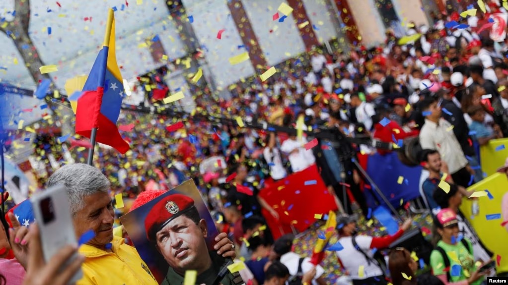 Una persona sostiene una imagen del difunto expresidente venezolano Hugo Chávez durante un mitin del gobierno para conmemorar el Día de la Juventud, en Caracas, Venezuela, el 12 de febrero de 2023.
